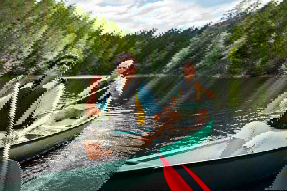 A couple on holiday taking a canoe ride.