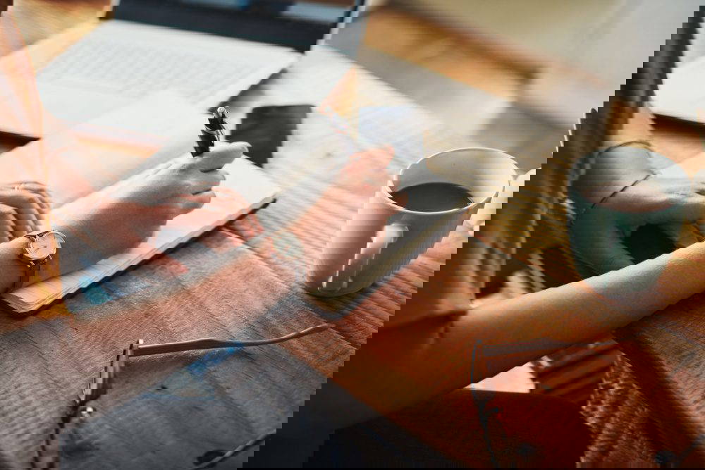 A woman making notes in a diary.