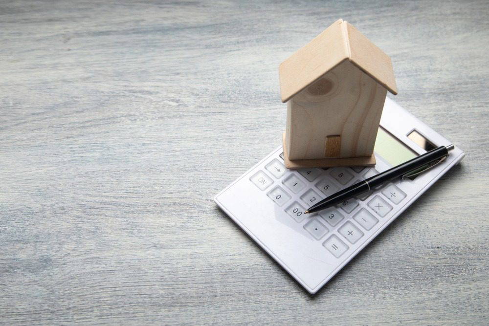 A calculator and a model of a home.